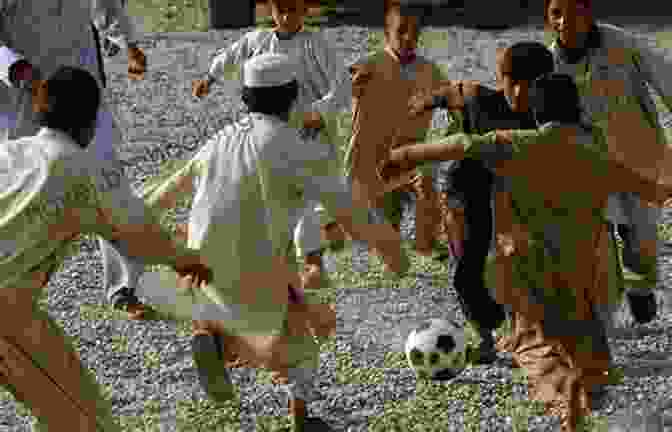 A Group Of Afghan Children Playing Soccer In A Field Afghanistan At A Time Of Peace